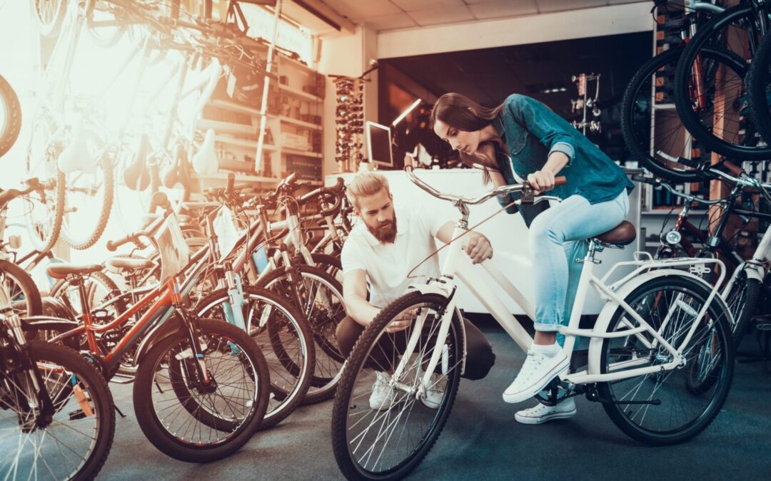 two people are working on a bicycle in a store